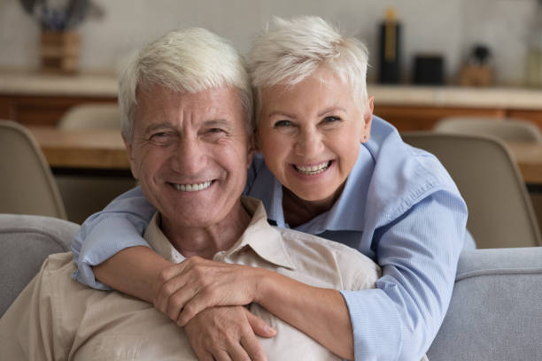 Grey-haired grandparents pose
